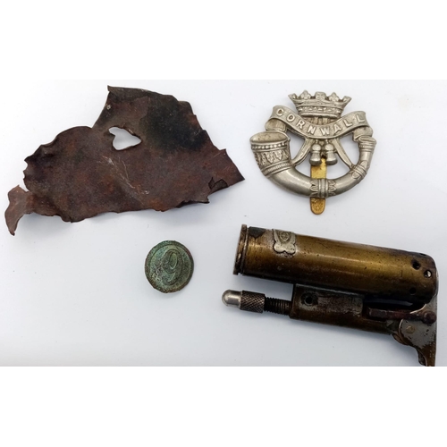 576 - WW1 British Tommie’s Xmas Tin Circa 1914. Containing a cap badge, button, shrapnel and trench lighte... 