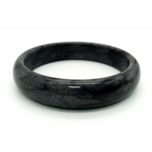 1356 - A Shades of Grey Coloured Jade Bangle. 6cm inner diameter.