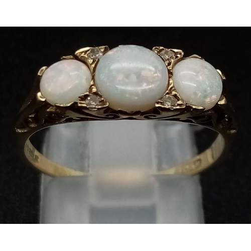 305 - An Antique 9K Yellow Gold Opal and Diamond Ring. Three opals and four diamonds set in scroll decorat... 