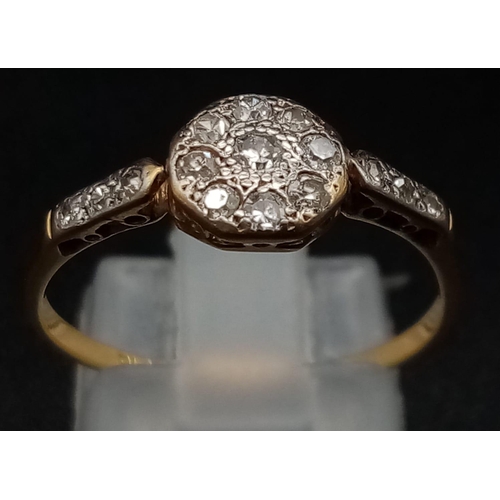 326 - An Edwardian 18K Yellow Gold and Platinum Diamond Ring. 
Nine diamonds within an octagon, compliment... 