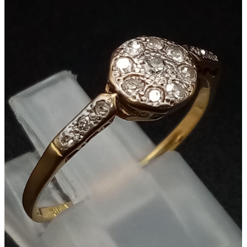 326 - An Edwardian 18K Yellow Gold and Platinum Diamond Ring. 
Nine diamonds within an octagon, compliment... 