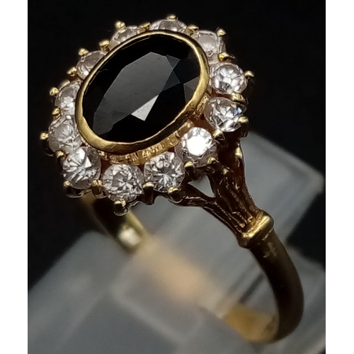 333 - An 18K Yellow Gold Sapphire and CZ Ring. Quality central oval cut sapphire with a bright CZ stone su... 