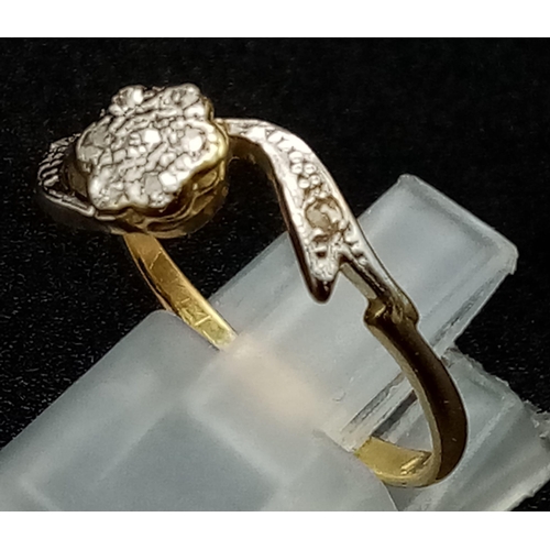 960 - An Edwardian 18K Gold and Platinum Floral-Twist Diamond Ring. Size P. 2.3g total weight.