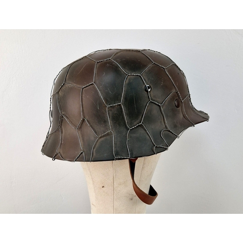 769 - Reproduction WW2 German M35 Helmet with D-Day Style Chicken Wire. A very nice copy. Ideal as a space... 