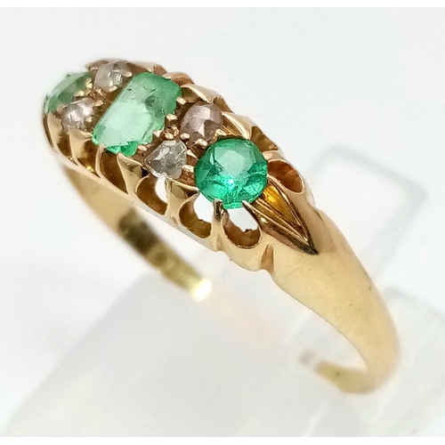 262 - An 18 K yellow gold ring with three round cut emeralds (0.50 carats) and old cut diamonds (0.12 cara... 