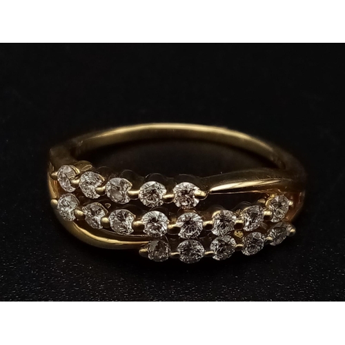 306 - An 18K yellow gold ring with three diamond bands (0.36 carats). Ring size: J, weight: 2.4 g.