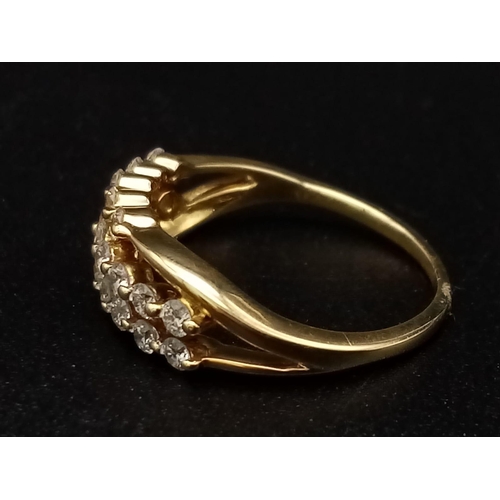 306 - An 18K yellow gold ring with three diamond bands (0.36 carats). Ring size: J, weight: 2.4 g.