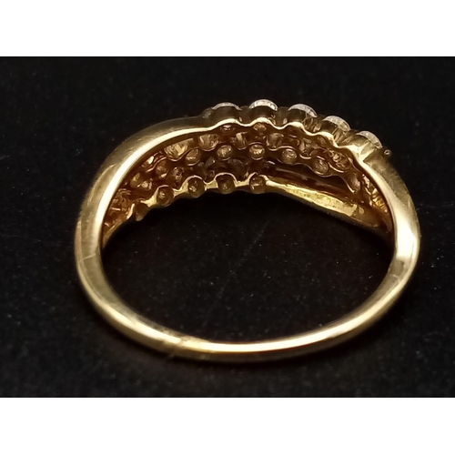 306 - An 18K yellow gold ring with three diamond bands (0.36 carats). Ring size: J, weight: 2.4 g.