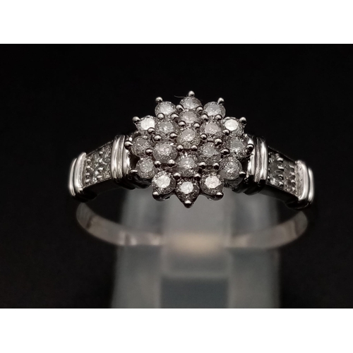 283 - A 9K white gold ring with a cluster of diamonds and further diamonds on shoulders (diamonds 0.30 car... 