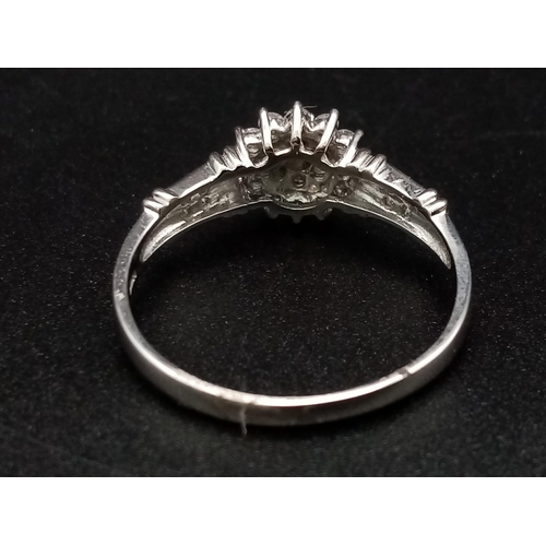 283 - A 9K white gold ring with a cluster of diamonds and further diamonds on shoulders (diamonds 0.30 car... 