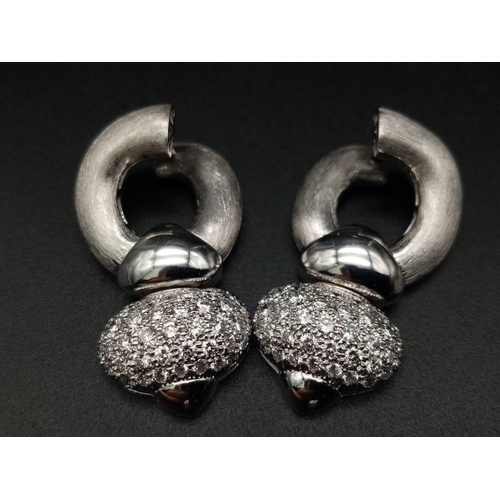 1011 - A beautifully designed, 18K white gold, pair of earrings with large diamond cluster. (app 4 carats).... 