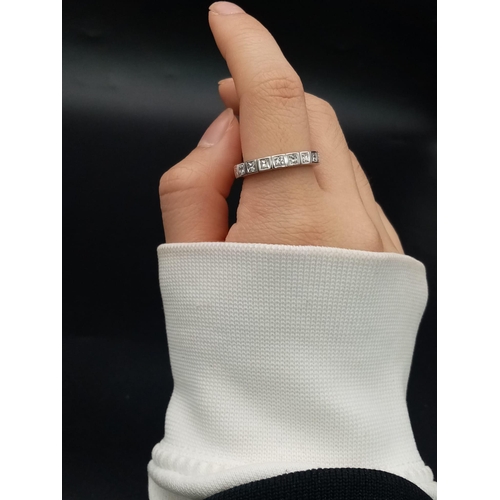 1040 - A platinum eternity ring with Princess cut diamonds (app. 2.5 carats). Ring size: N, weight: 5 g.