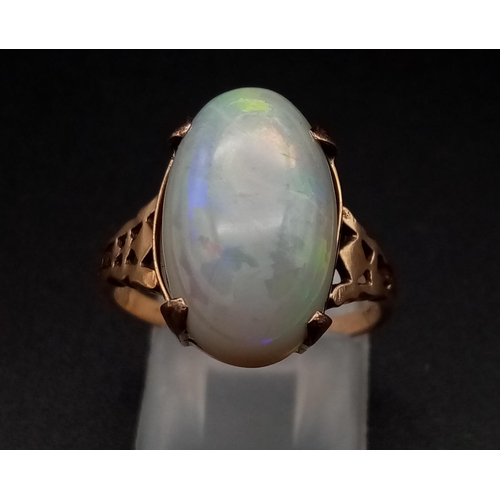 1068 - A vintage, 9K yellow gold ring with an Australian large opal cabochon, exhibiting good iridescence. ... 