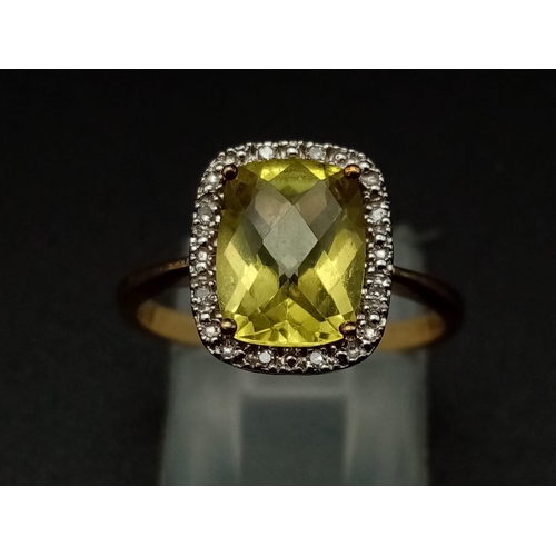 1265 - A 9K yellow gold ring with a large mix cut yellow beryl (app. 6 carats) surrounded by a halo of diam... 