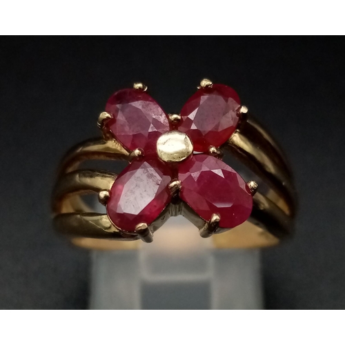 1285 - A 9K yellow gold ring with three bands supporting four oval cut rubies. Ring size: N, weight: 4.29 g... 