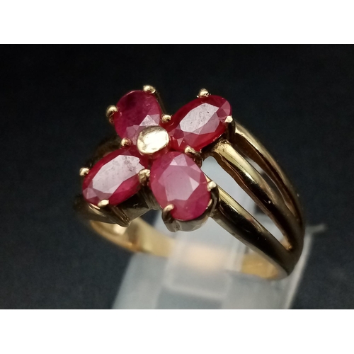 1285 - A 9K yellow gold ring with three bands supporting four oval cut rubies. Ring size: N, weight: 4.29 g... 