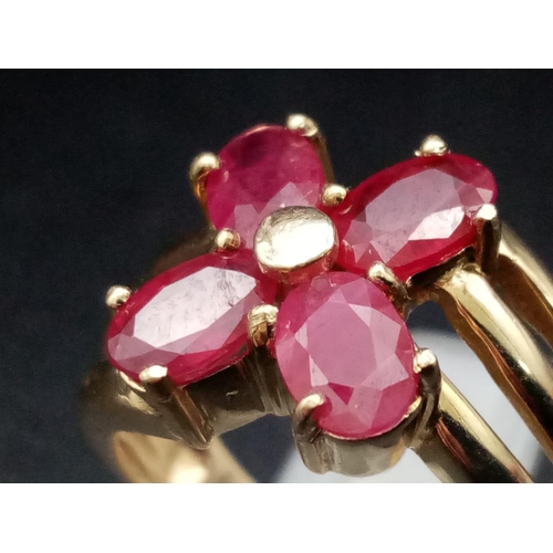 1285 - A 9K yellow gold ring with three bands supporting four oval cut rubies. Ring size: N, weight: 4.29 g... 