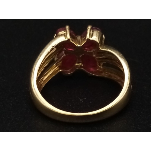 1285 - A 9K yellow gold ring with three bands supporting four oval cut rubies. Ring size: N, weight: 4.29 g... 