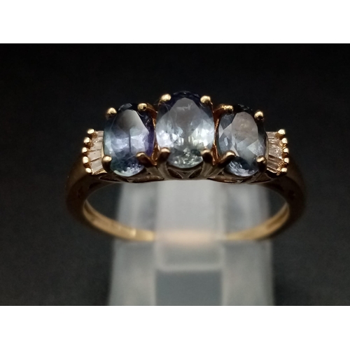 1289 - A 9K yellow gold ring with three oval cut tanzanite stones. Ring size: P1/2, weight: 2.56 g.