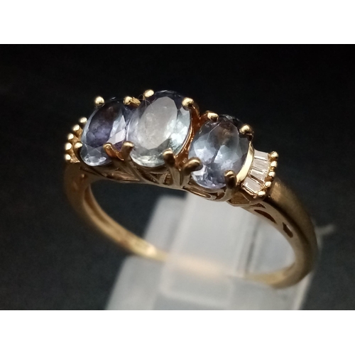 1289 - A 9K yellow gold ring with three oval cut tanzanite stones. Ring size: P1/2, weight: 2.56 g.