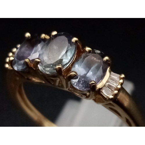 1289 - A 9K yellow gold ring with three oval cut tanzanite stones. Ring size: P1/2, weight: 2.56 g.