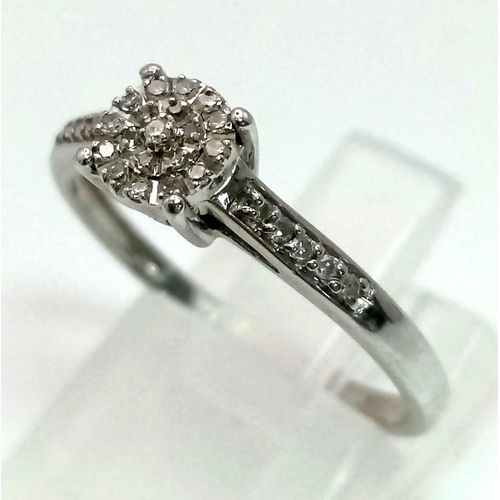 471 - A 9K white gold ring with a diamond cluster and further diamonds on shoulders (diamonds 0.30 carats)... 