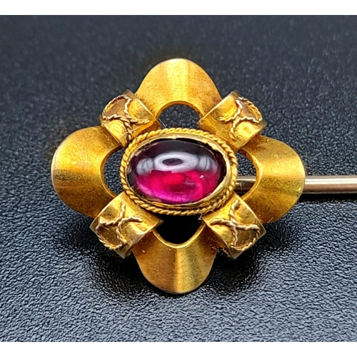 1282 - A Victorian High-Karat Gold and Almadine Cabochon Long Stick Pin. 8cm. 3.23g total weight. Comes in ... 