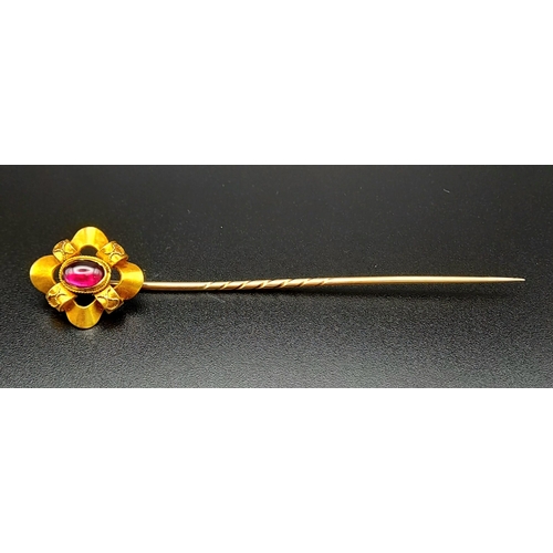 1282 - A Victorian High-Karat Gold and Almadine Cabochon Long Stick Pin. 8cm. 3.23g total weight. Comes in ... 