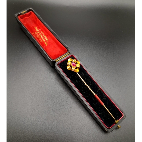 1282 - A Victorian High-Karat Gold and Almadine Cabochon Long Stick Pin. 8cm. 3.23g total weight. Comes in ... 