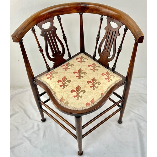 1302 - A VICTORIAN CORNER CHAIR TASTEFULLY REUPHOLSTERED WITH CURVED BACK REST ON HARP SHAPED STRUTTS.