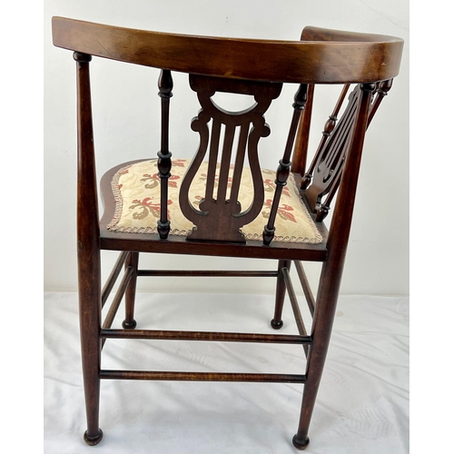 1302 - A VICTORIAN CORNER CHAIR TASTEFULLY REUPHOLSTERED WITH CURVED BACK REST ON HARP SHAPED STRUTTS.