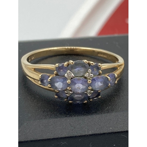 154 - 9k GOLD RING set to top with synthetic TANZANITE gemstones. Attractive gold openwork Shoulders. Full... 