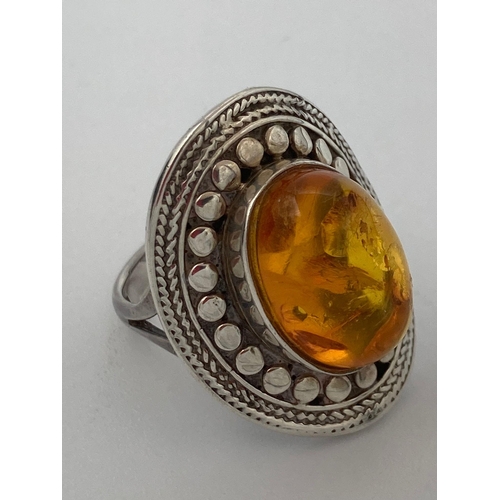 175 - Vintage AMBER CABOCHON SILVER RING, having oval Amber Cabochon Mounted to top with attractive curved... 