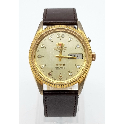 351 - A Vintage Orient 21 Jewel Crystal Gents Watch. Brown leather strap. Two tone case - 36mm. Gold tone ... 