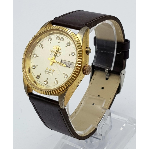 351 - A Vintage Orient 21 Jewel Crystal Gents Watch. Brown leather strap. Two tone case - 36mm. Gold tone ... 