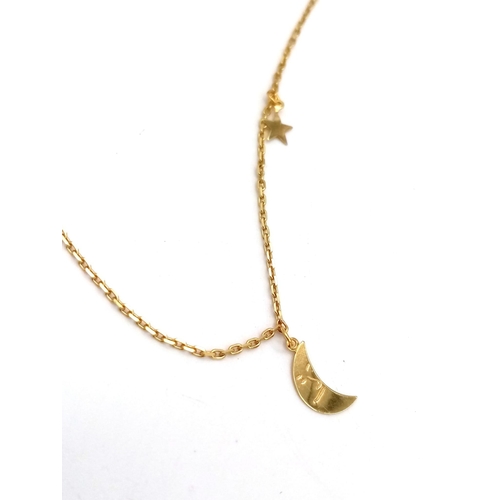 430 - A 14K yellow gold chain necklace with two pendant/ charms a half moon and a star. Chain length: 41 c... 