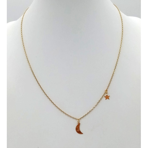 430 - A 14K yellow gold chain necklace with two pendant/ charms a half moon and a star. Chain length: 41 c... 