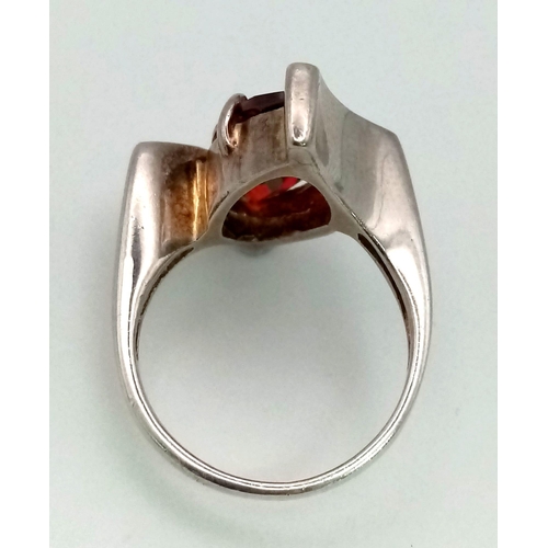 814 - A sterling silver lot with red cubic zirconia including a pair of heart shaped earrings, a heart sha... 