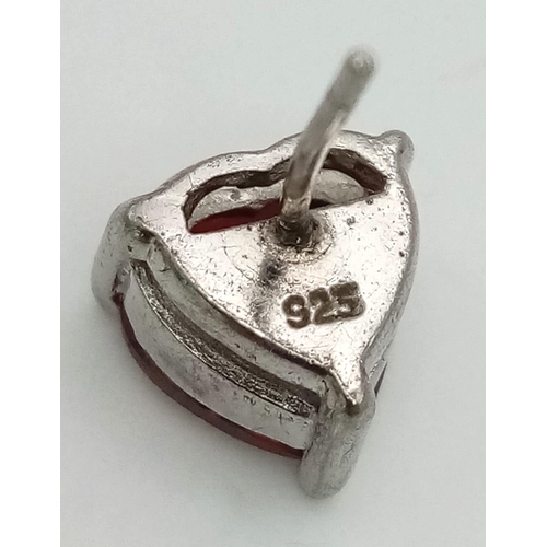 814 - A sterling silver lot with red cubic zirconia including a pair of heart shaped earrings, a heart sha... 