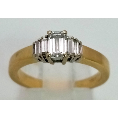 1564 - An 18K Yellow Gold Graduating Emerald-Cut Diamond Ring. 
Size K/L. 4.07g total weight. 0.48ct.