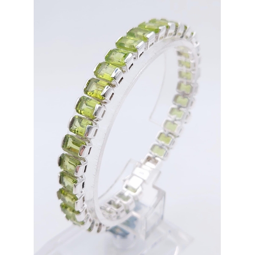 1573 - 925 Sterling Silver Peridot Tennis Bracelet. Total Weight 25.74grams 20cm in length.