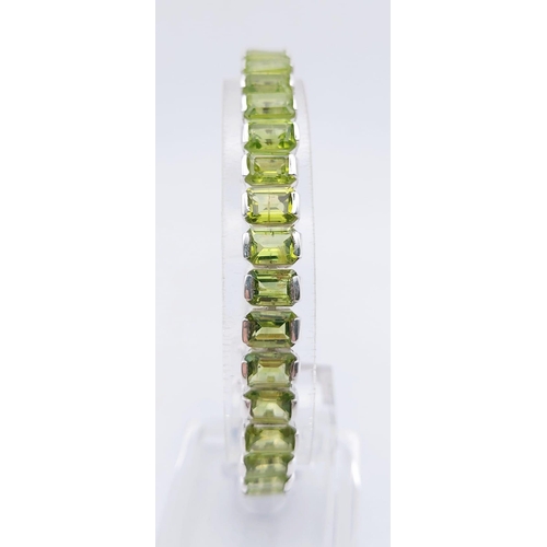 1573 - 925 Sterling Silver Peridot Tennis Bracelet. Total Weight 25.74grams 20cm in length.