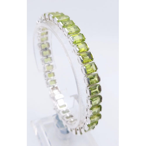 1573 - 925 Sterling Silver Peridot Tennis Bracelet. Total Weight 25.74grams 20cm in length.