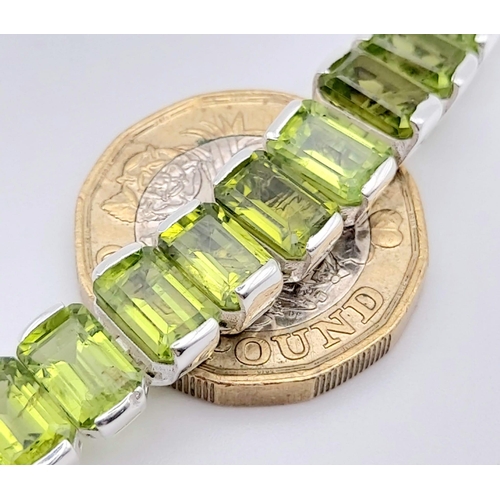 1573 - 925 Sterling Silver Peridot Tennis Bracelet. Total Weight 25.74grams 20cm in length.