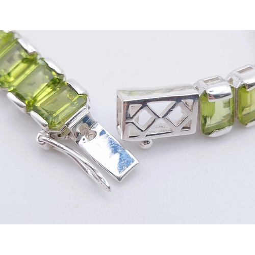 1573 - 925 Sterling Silver Peridot Tennis Bracelet. Total Weight 25.74grams 20cm in length.