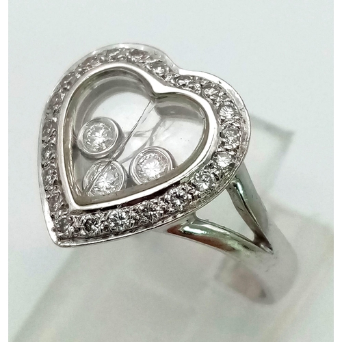 1523 - AN 18K WHITE GOLD AND FLOATING DIAMOND HEART RING.  5.3gms   size J