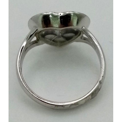 1523 - AN 18K WHITE GOLD AND FLOATING DIAMOND HEART RING.  5.3gms   size J