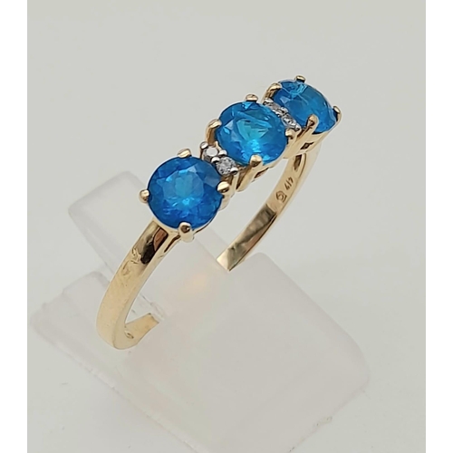 1574 - 10K Yellow Gold Ring with Trilogy of Bright Blue Stones, Buffered by white CZ. 2.5grams Size S.