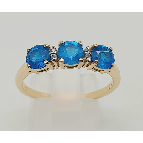 1574 - 10K Yellow Gold Ring with Trilogy of Bright Blue Stones, Buffered by white CZ. 2.5grams Size S.