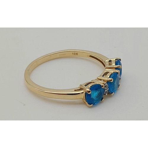 1574 - 10K Yellow Gold Ring with Trilogy of Bright Blue Stones, Buffered by white CZ. 2.5grams Size S.